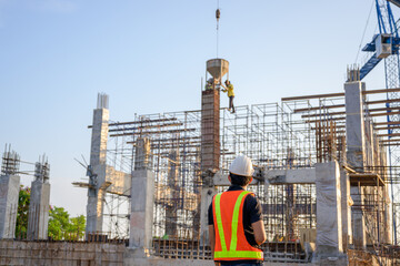 Construction engineers or managers and construction workers on a construction site Project work plan for designing houses and industrial buildings