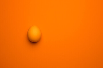 Orange Easter egg on an orange background.