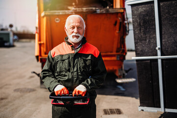 Portrait of a mature worker of the city utility company. Garbage collector.