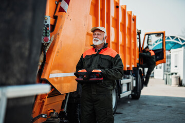 Portrait of a mature worker of the city utility company. Garbage collector.