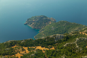 Trees burnt in forest fires of July 2021 in Marmaris resort town of Turkey from helicopter. Beautiful blue bays ans sea