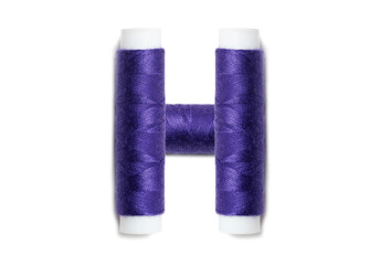 Letter of H from thread spools, isolated on white background. Alphabet concept.