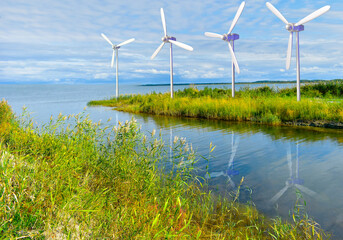 Wind turbines, green renewable , river, sea, water - 496483620
