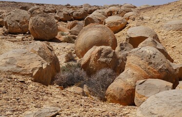 Unreally spherical rocks concretions in Nahal Keidar reserve, South Israel, sunset time, twilight