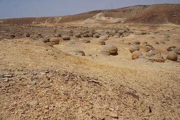 Unreally spherical rocks concretions in Nahal Keidar reserve, South Israel, sunset time, twilight