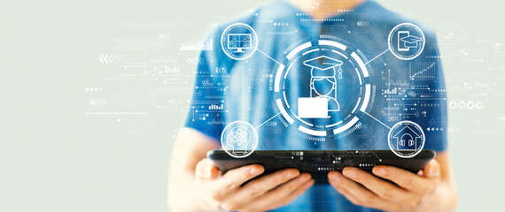 Distance learning theme with young man using a tablet computer