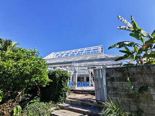 iron roof structure painted white and blue sky as background. Copy space.