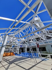 iron roof structure painted white and blue sky as background. Copy space.