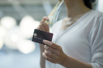 Woman shopping with credit card and cash