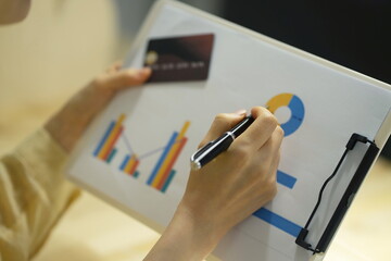 Woman reviewing graph with credit card