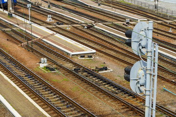 railway station infrastructure - rails, traffic light and platform without people