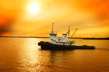 Tug in sunset over the sea
