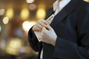 Businesswoman taking out money from jacket