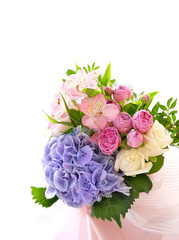 gentle beautiful bouquet with hydrangea, eustoma, roses flowers close up on white abstract background. romantic floral festive image.