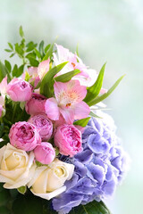 gentle beautiful bouquet with Hyacinth, eustoma, roses flowers close up, blurred abstract background. romantic floral festive image.