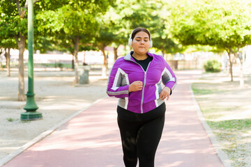 Latin fat woman running at the park