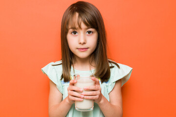 Beautiful brunette drinking some milk