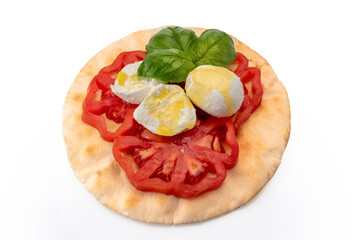 Caprese salad with tomato mozzarella olive oil and basil leaves on Italian flatbread bread, piadina, isolato su bianco, clipping path