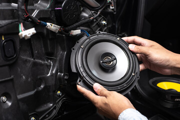 Technician installing the car speaker - 496497069