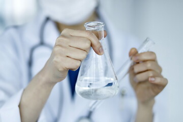 Doctor holding test tube and flask. Biotechnology,medicine,chemistry concept.