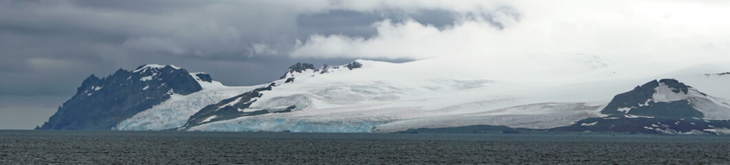 Panorama of rugged, snow covered peaks and glaciers in Antarctica