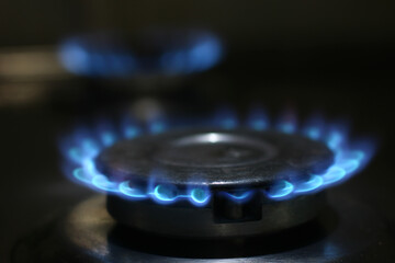 blue flame of burning gas in the kitchen stove