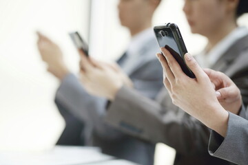 Close up of business people using smartphone. Business concept
