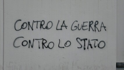 Europe, Italy , Milan April 2022 written on a wall against the state, against the war between...