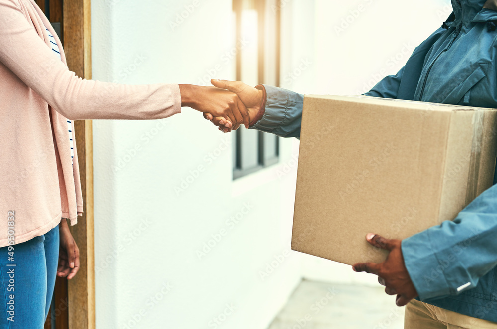 Poster our customers are always grateful for our speedy service. closeup shot of a courier shaking hands wi
