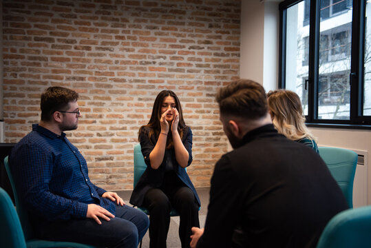 a woman shares her experiences at the group therapy seasion