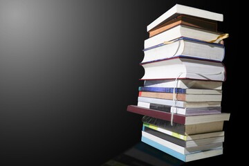 books stacked vertically on a black background