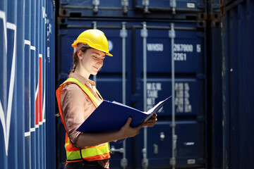 Young Engineers standing in the shipping yard tracking the cargo inventory and checking container box for safety.	