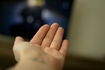 Empty hand on blurred background.Woman hand showing palm.