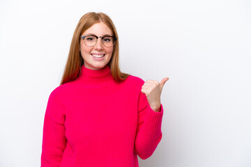 Young redhead woman isolated on white background pointing to the side to present a product