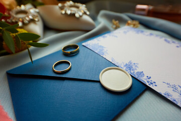 Wedding rings and wedding invitation. Shallow dof