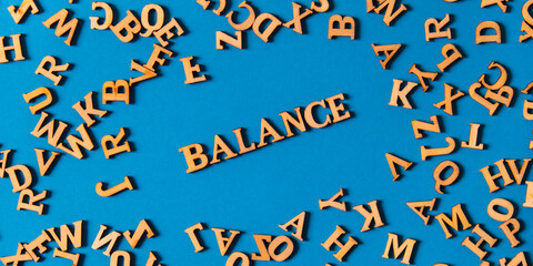 Word BALANCE made out of wooden letters on bright blue background. Motivational Words Quotes...