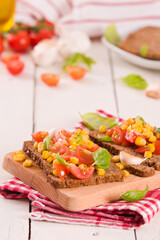 Rye bread withsweet corn, basil and tomato.