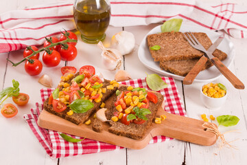 Rye bread withsweet corn, basil and tomato.
