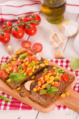 Rye bread withsweet corn, basil and tomato.