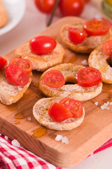 Friselle with cherry tomatoes and olive oil.