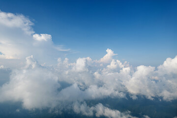 Fototapeta na wymiar Aerial view clouds and blue sky from airplane window