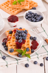 Waffles with blueberries and jam. 
