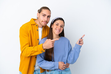 Young caucasian couple isolated on white background pointing finger to the side and presenting a product