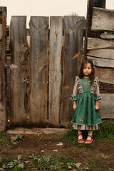 cute children in beautiful green dresses walking on a farm