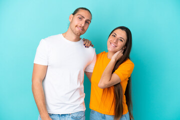 Fototapeta premium Young caucasian couple isolated on blue background happy and laughing