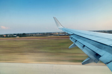 View of air plane wing during take off, motion blur effect