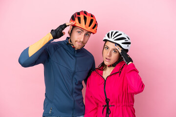 Young cyclist caucasian people isolated on pink background has just realized something and has intending the solution