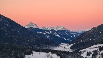 Sunrise over snow capped mountain peaks of Karawanks in Carinthia, Austria. Julian Alps. Scenic...