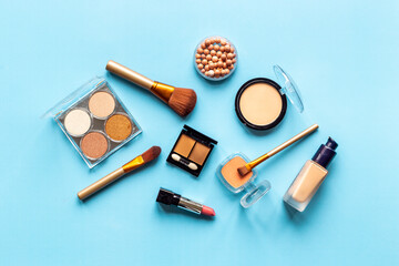 Decorative makeup cosmetic on color background, top view