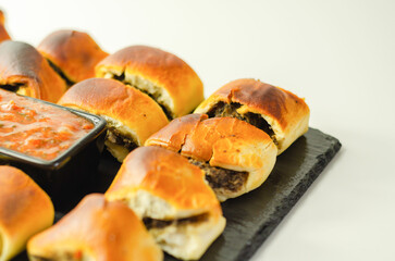 Patty's pies stuffed with minced meat, mushrooms and onion, served with sauce